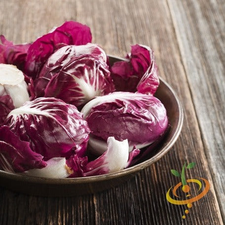 Bowl of classic red radicchio with white veins on a wooden surface