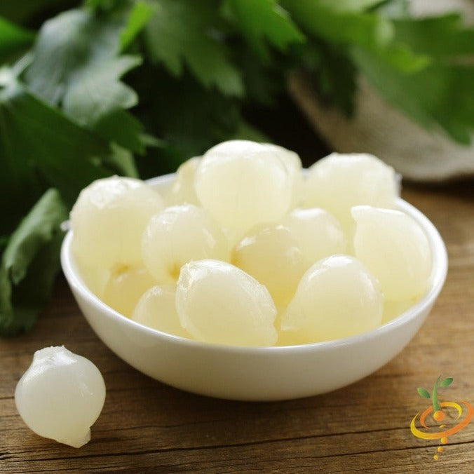 Pearly White Barletta onion seeds from SeedsNow, small round seeds with a light tan color on a white background.
